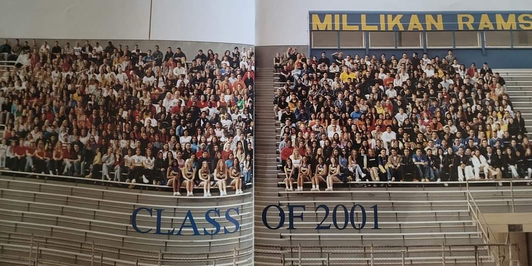 Millikan High School Class of 2001 group photo - hundreds of students gathered on bleachers with MILLIKAN RAMS sign visible
